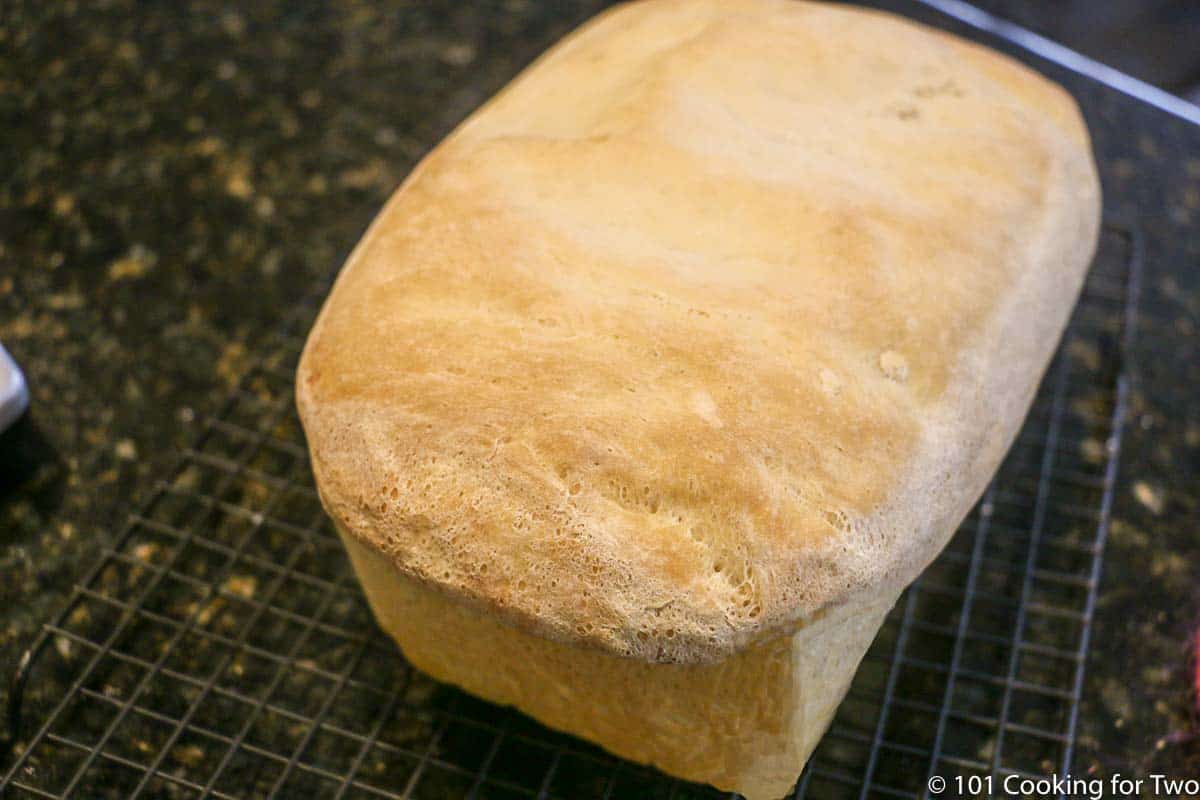 baked loaf of bread on cooling rack