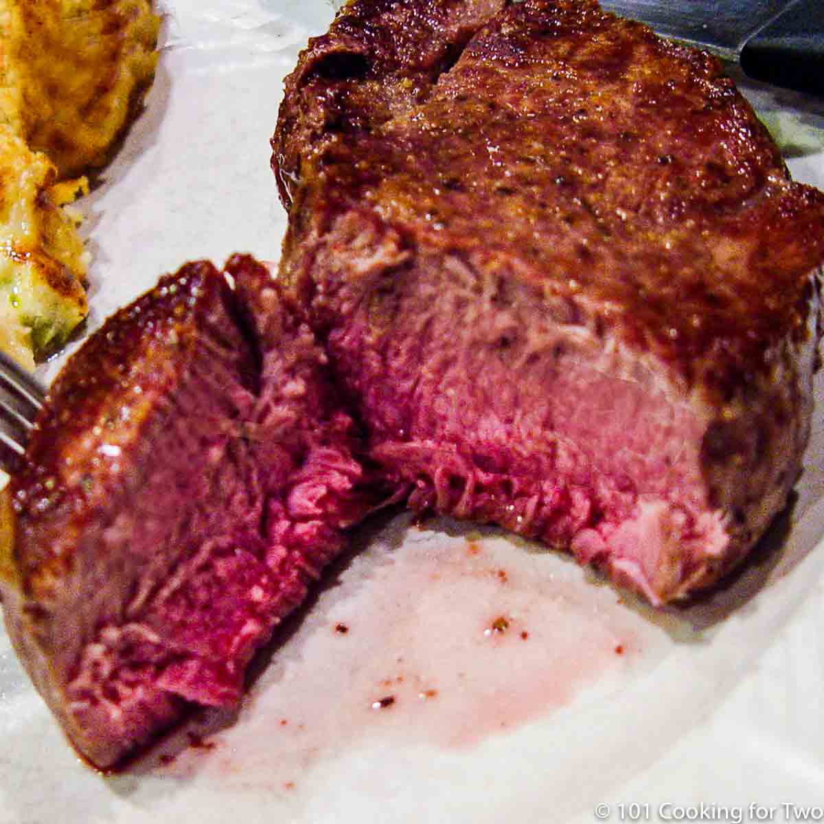 cut filet cooked on a white plate