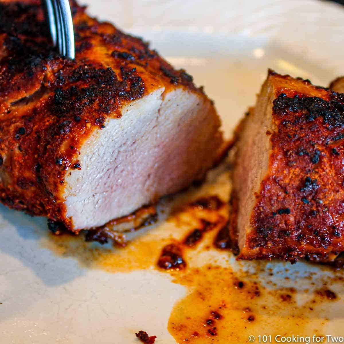 cut pork tenderloin on white plate