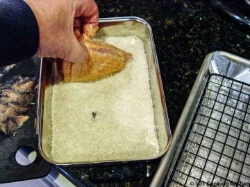 dipping chicken in the coating mixture