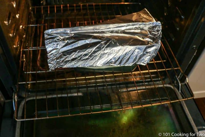 loaf pan in oven tented lightly with foil