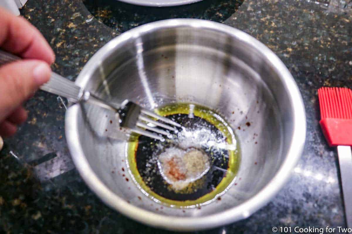 mixing marinade in metal bowl