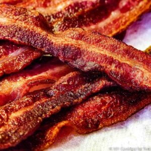 pile of bacon on a white plate