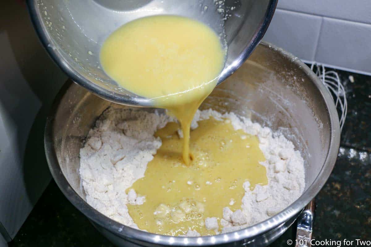 pouring wet mixture into dry mix