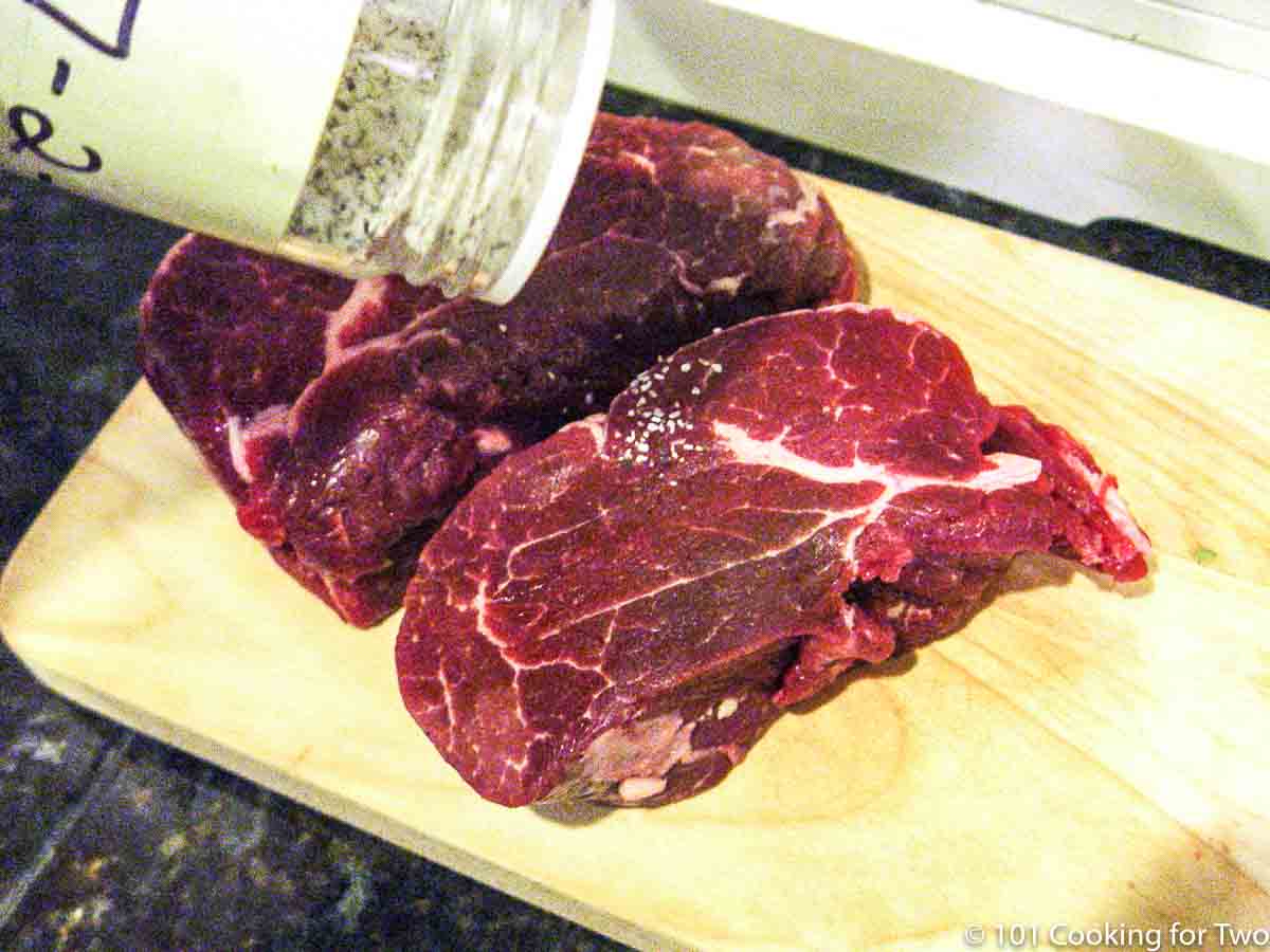 seasoning filets on a wooden board