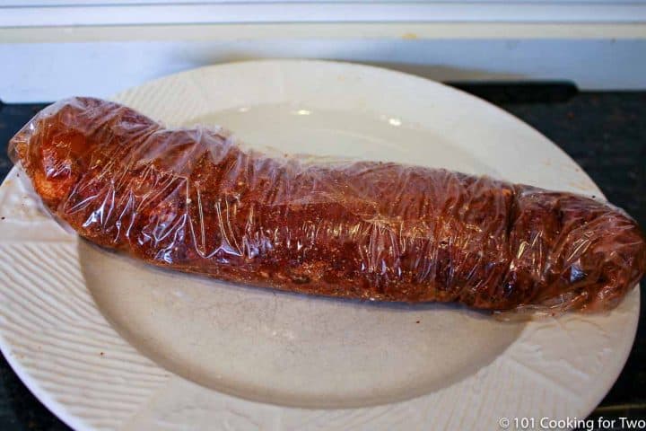 tenderloin with rub wrapped tightly in plastic wrap