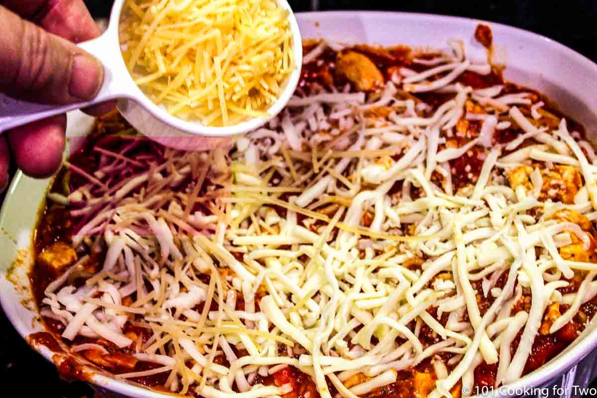 adding cheese to top of casserole.