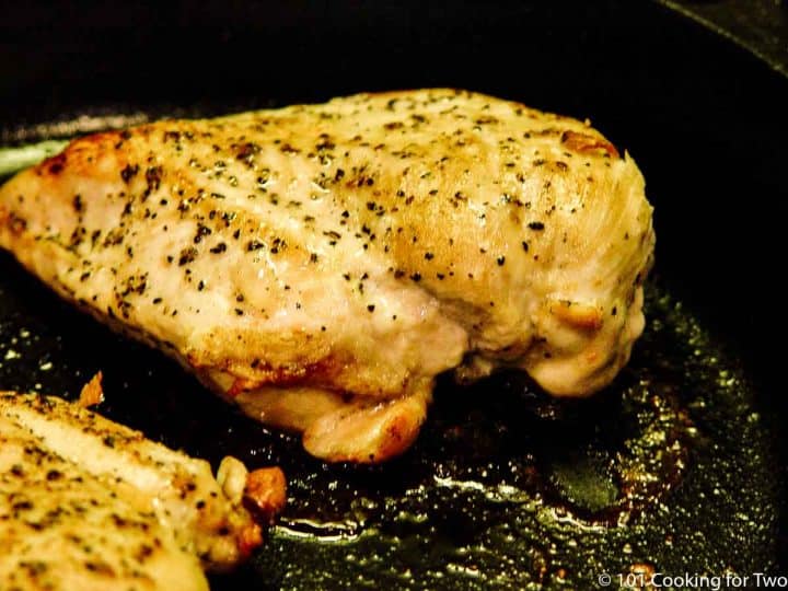 cooked chicken breast in cast iron skillet