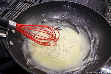 making a roux in a pan with a whisk