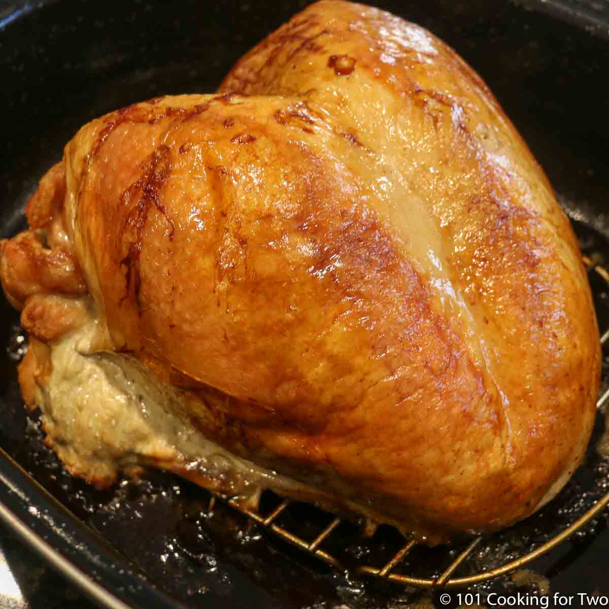 roasted whole turkey breast in a pan.