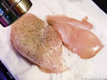 seasoning raw chicken breast sith salt