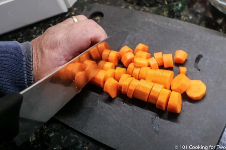 slicing carrots on a black board