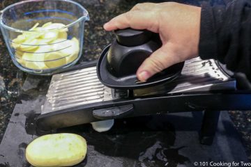 slicing potatoes with a mandolin
