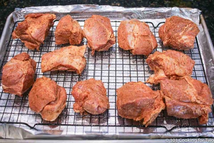 spice covered pork on the rack and tray
