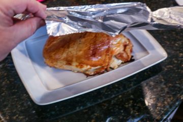 tenting turkey breast with foil on plate