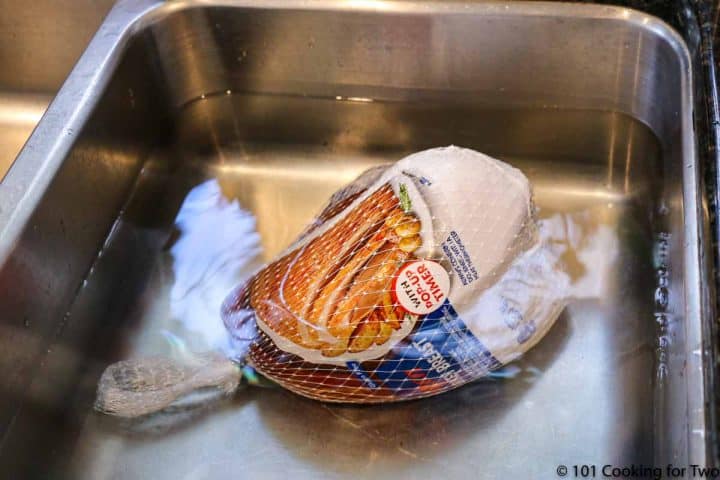turkey breast in sink with water