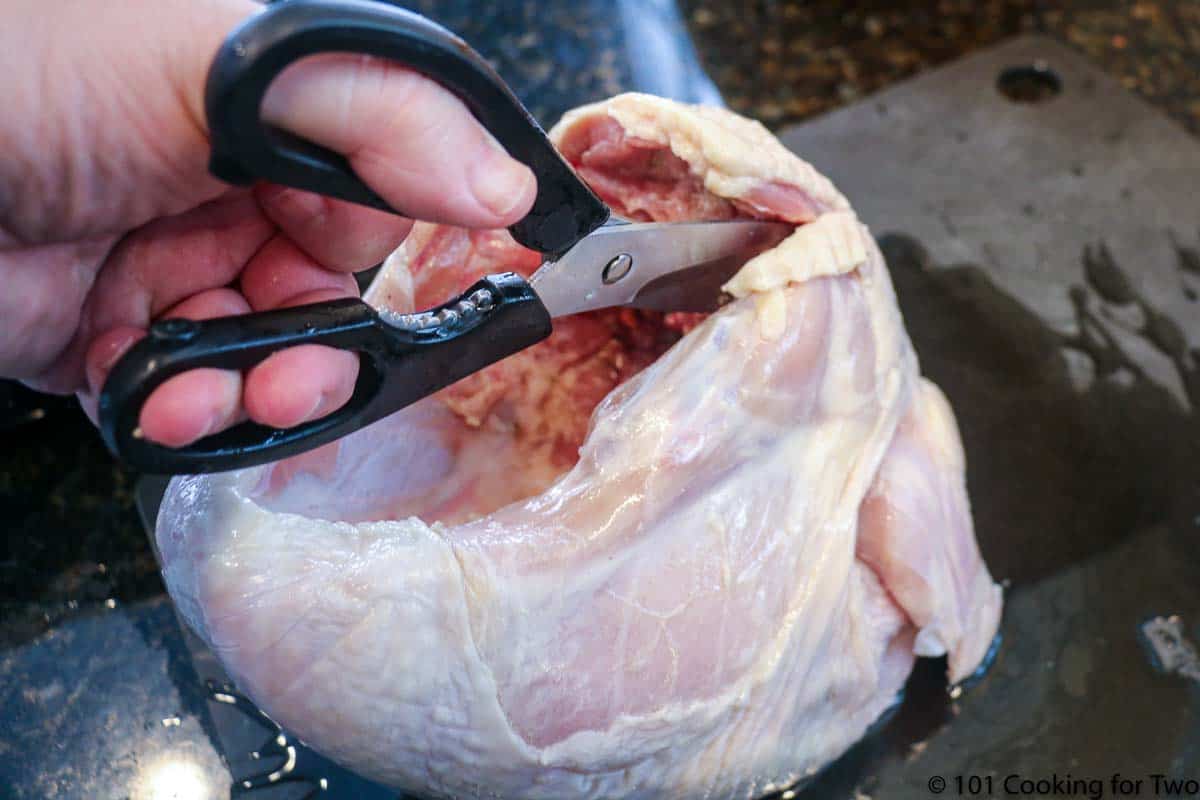 using shires cutting backborn from turkey breast.