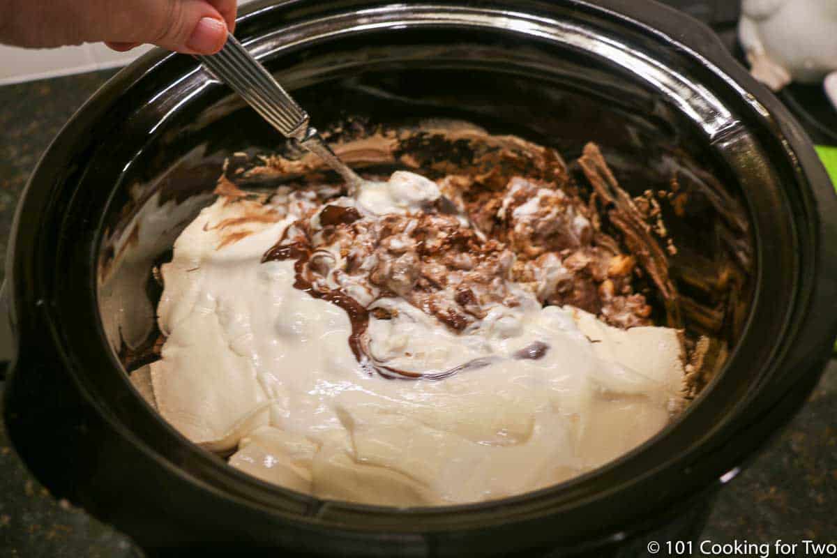 melted chocolate in crock pot mixing with spoon