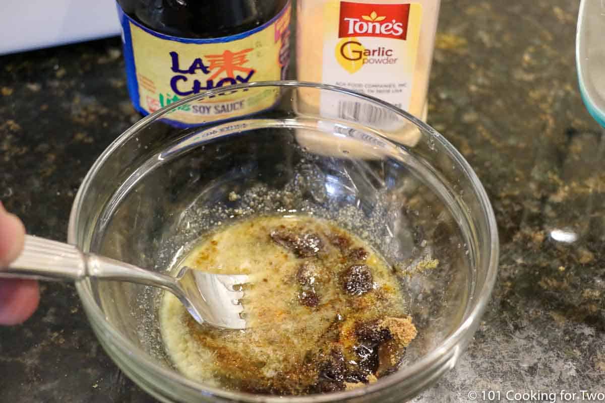 mixing topping for beans in glass bowl.