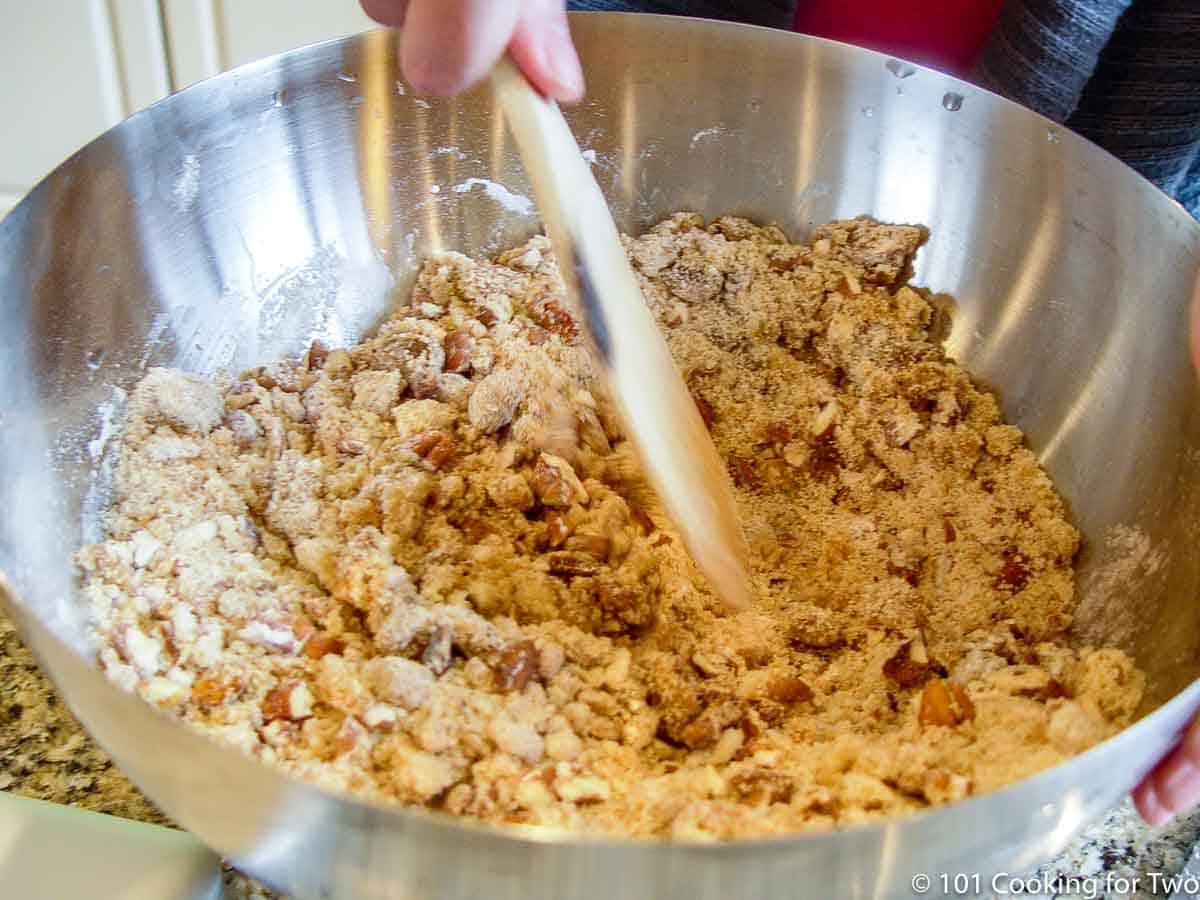 mixing topping with wooden spoon in bowl