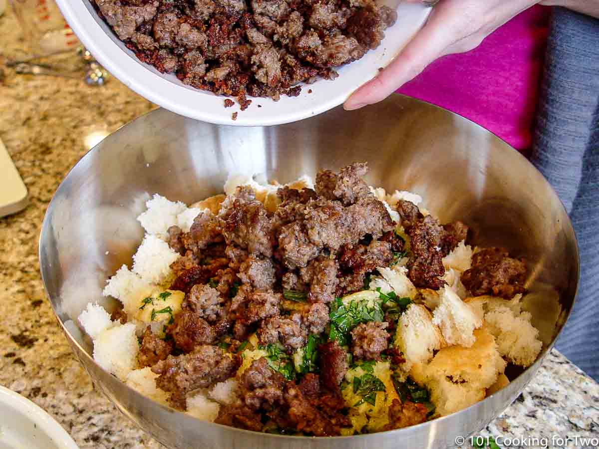 adding sausage to bowl with other ingredients.