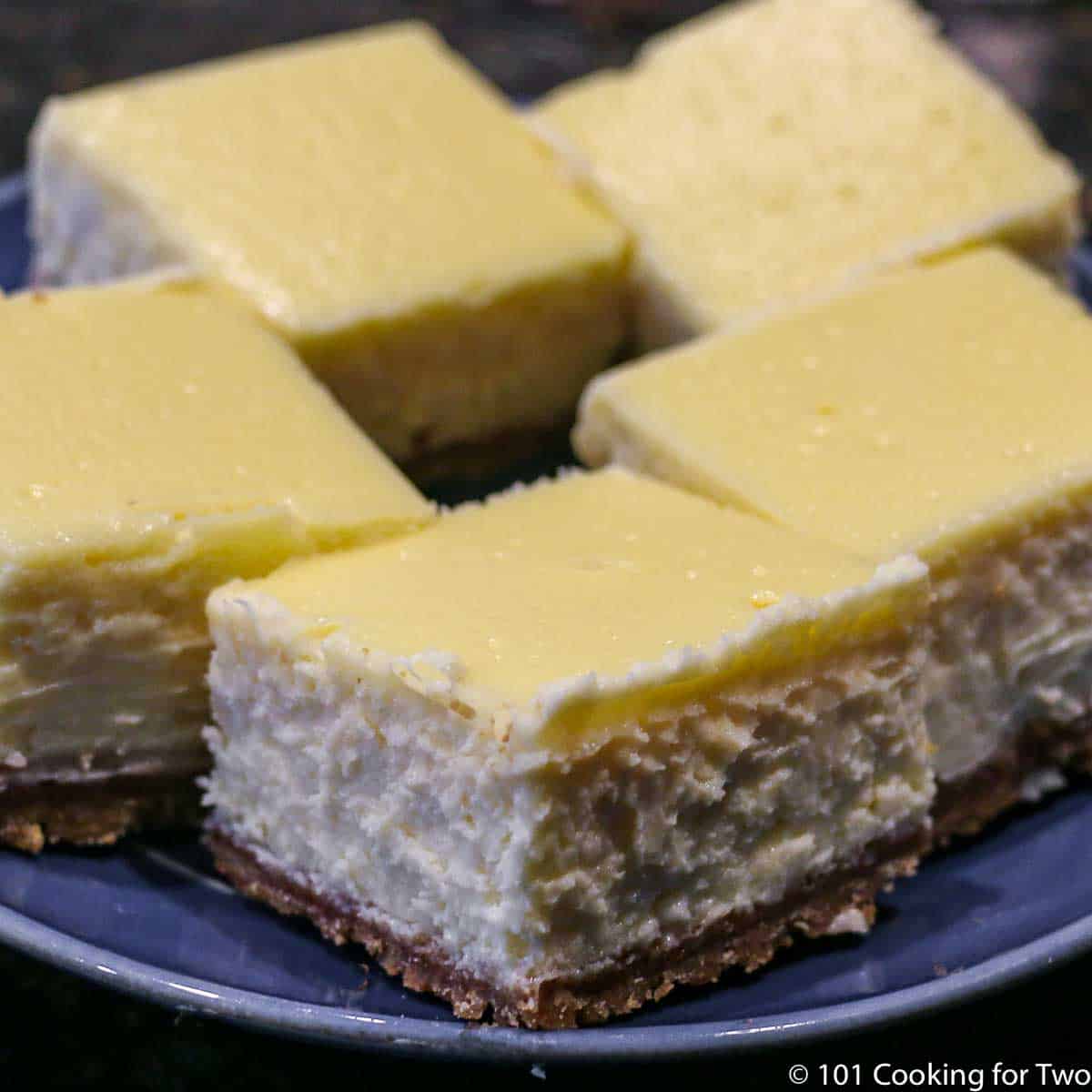 cheesecake bars on a blue plate