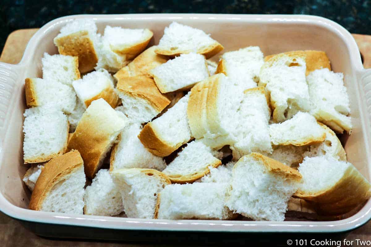 cubes of bread in a small casserole dish.