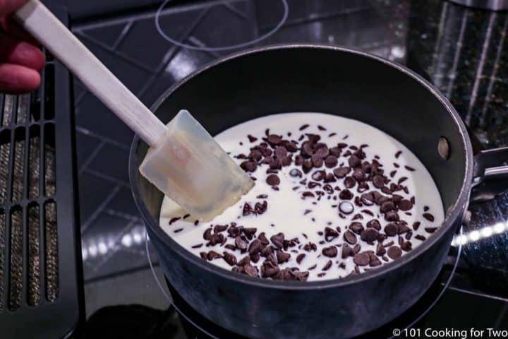 melting chocolate in pan with milk