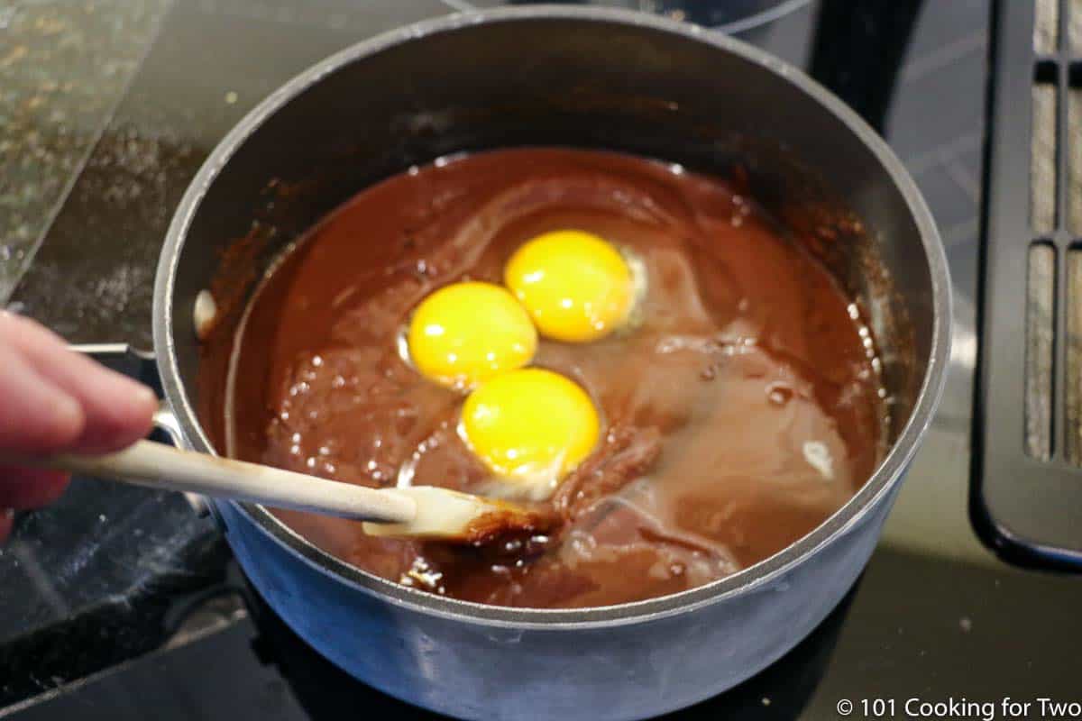 mixing eggs into the batter