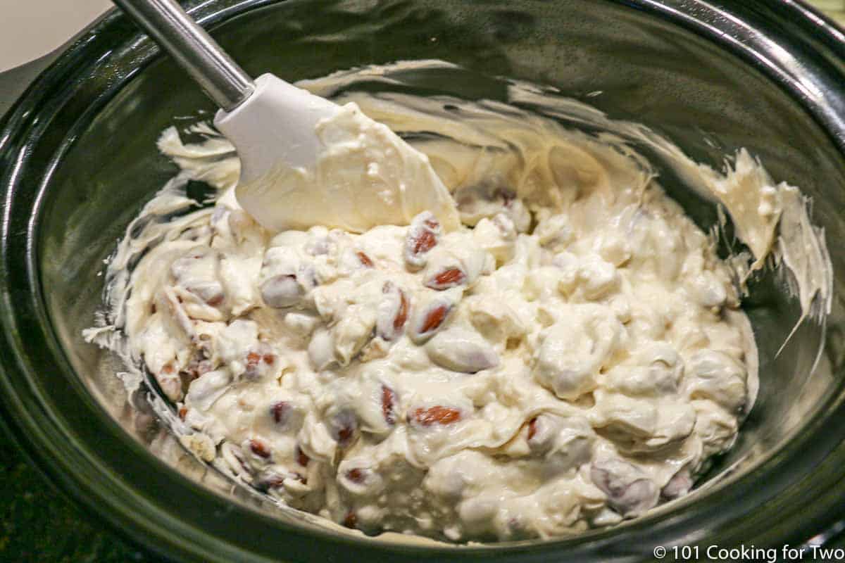 mixing melted chocolate with the nuts with a spatula