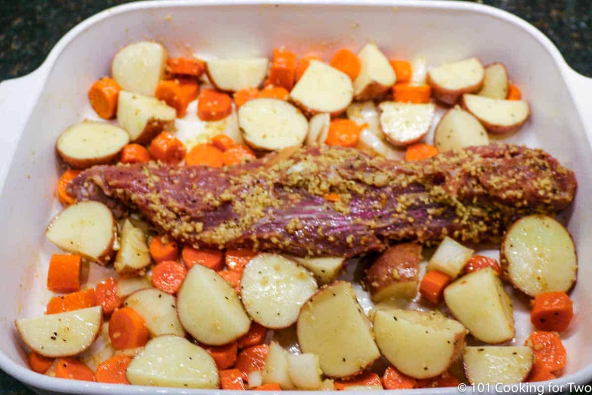 pork tenderloin with veggies in baking dish raw