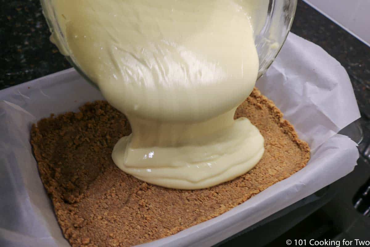 pouring batter into prepared pan with crust