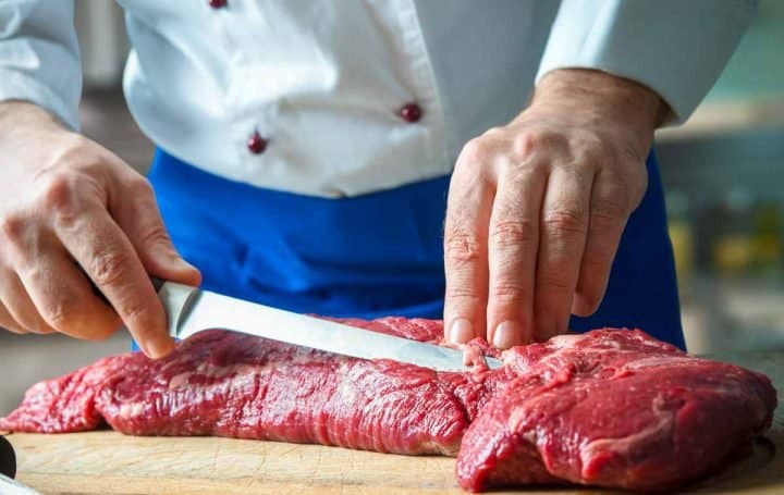 Chef trimming beef tenderloin. ©Alexander Raths - stock.adobe.com 2018