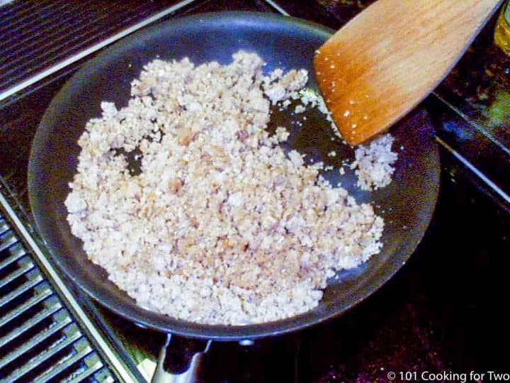 bread crumbs in skillet with wooden spoon