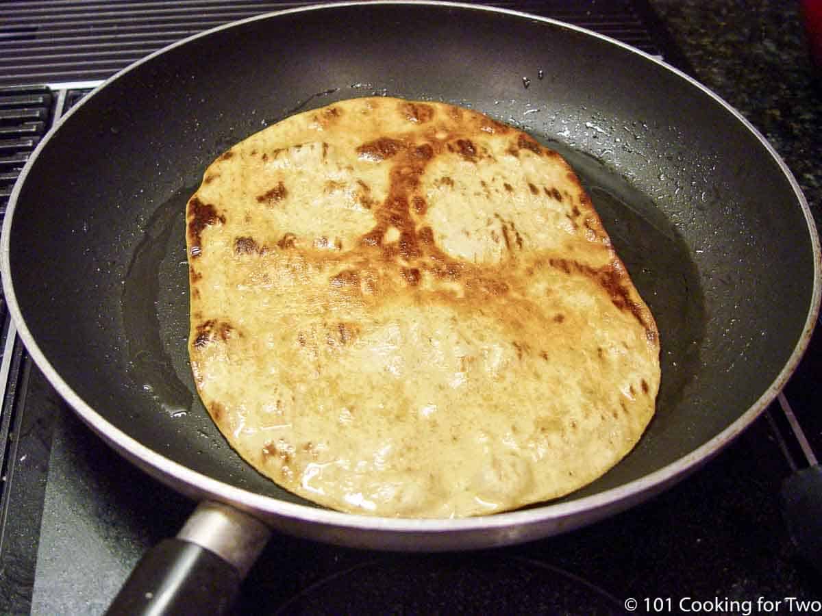 browned flat bread in a fry pan.