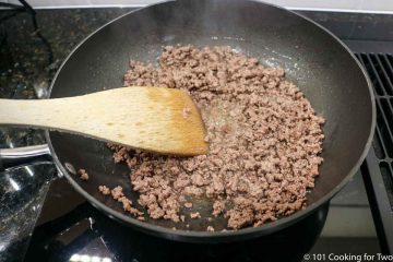 browning ground meat in a black pan