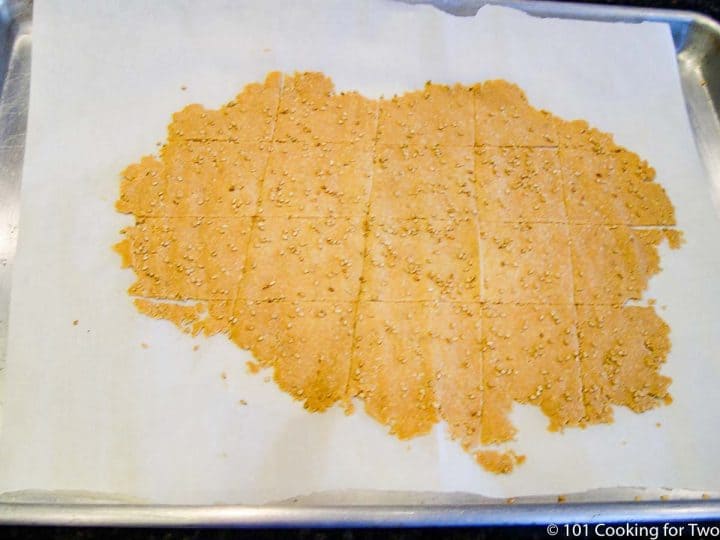 cooked slab of crackers on parchment paper