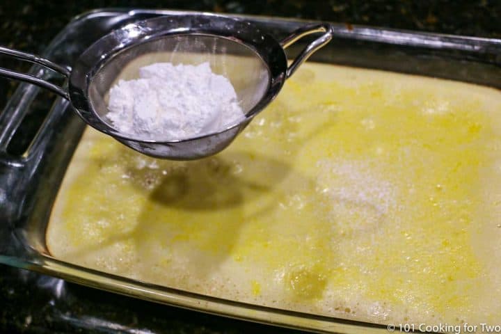 dusting cooked lemon bars with powder sugar