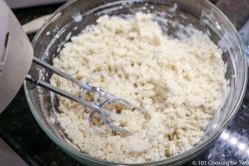 mixing crust dough of butter with flour and sugar with electric mixer