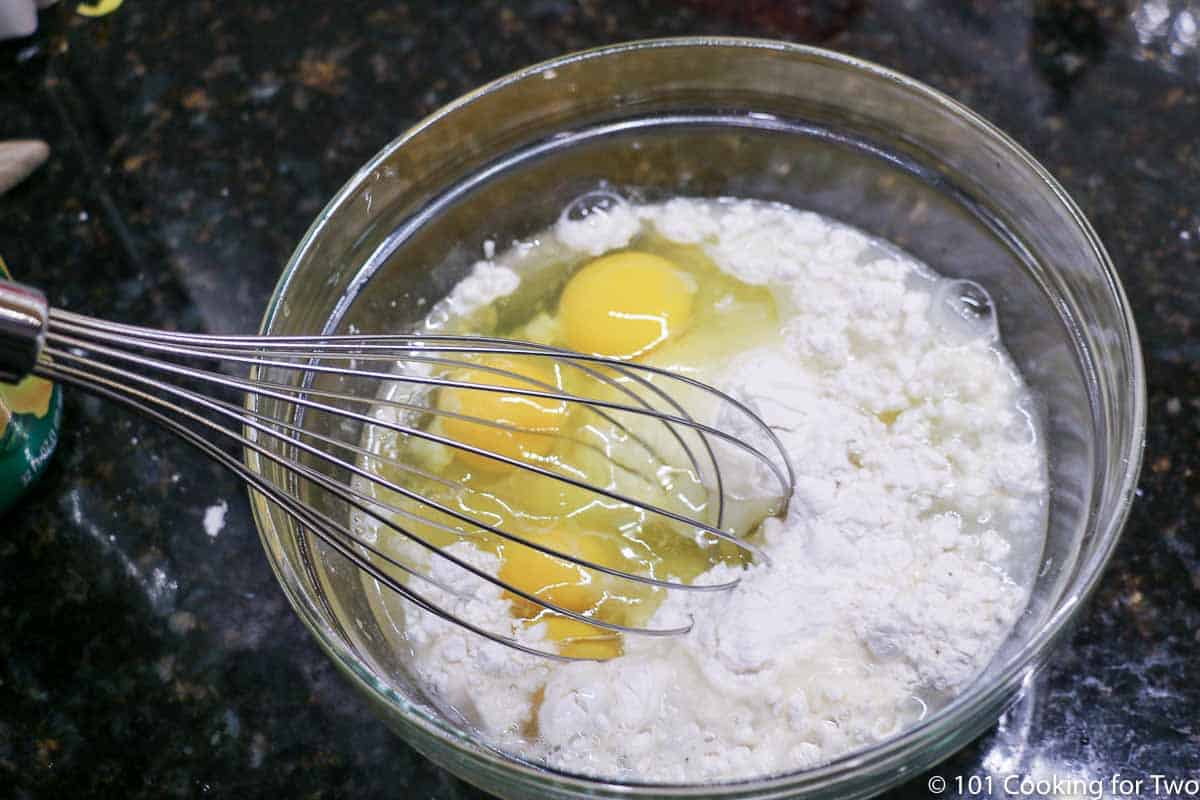 mixing filling with whisk in a glass bowl