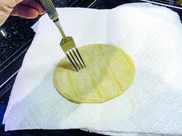 poking a tortilla with a fork