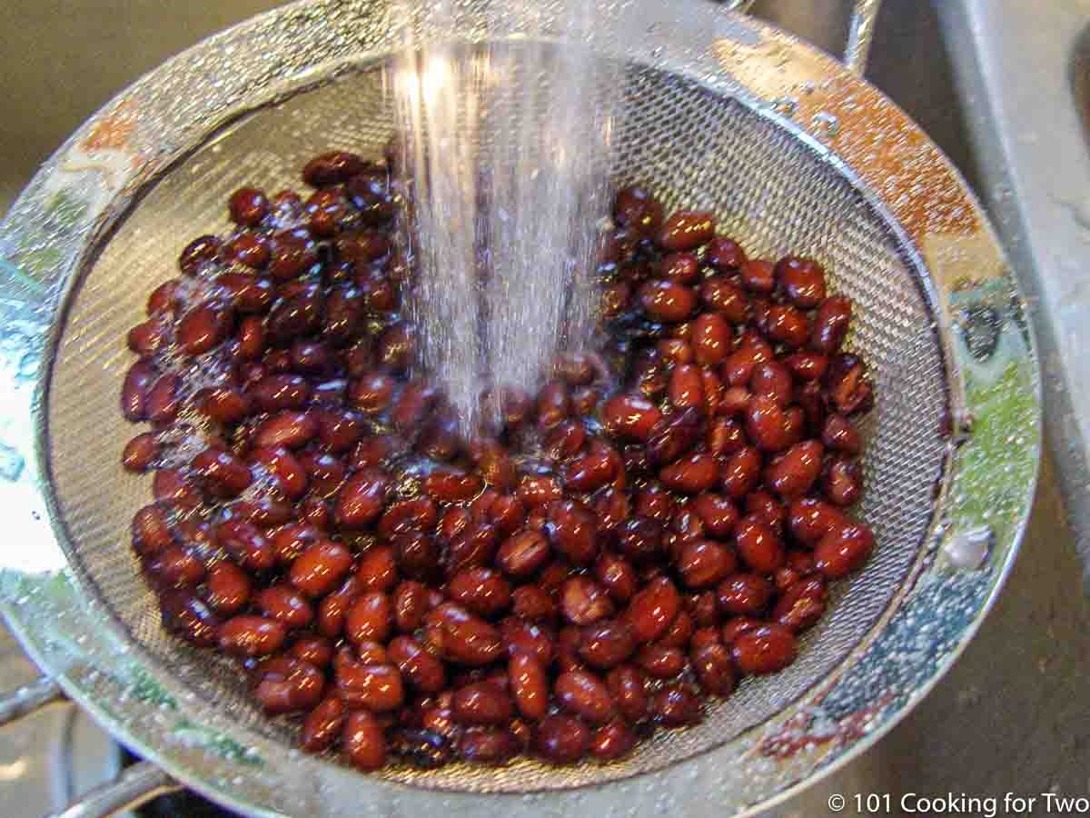 rinsing beans under running water.