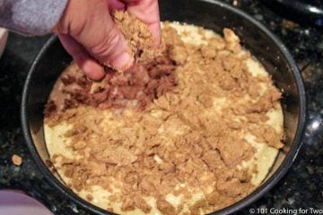 adding topping to coffeecake