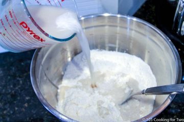 adding wet ingredients into dry ingredients