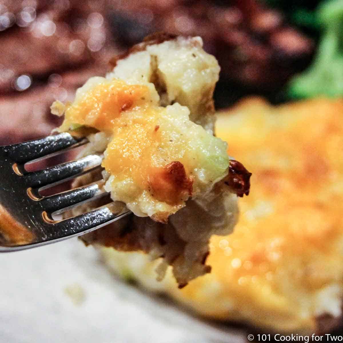 bite of twice baked potato on a fork.