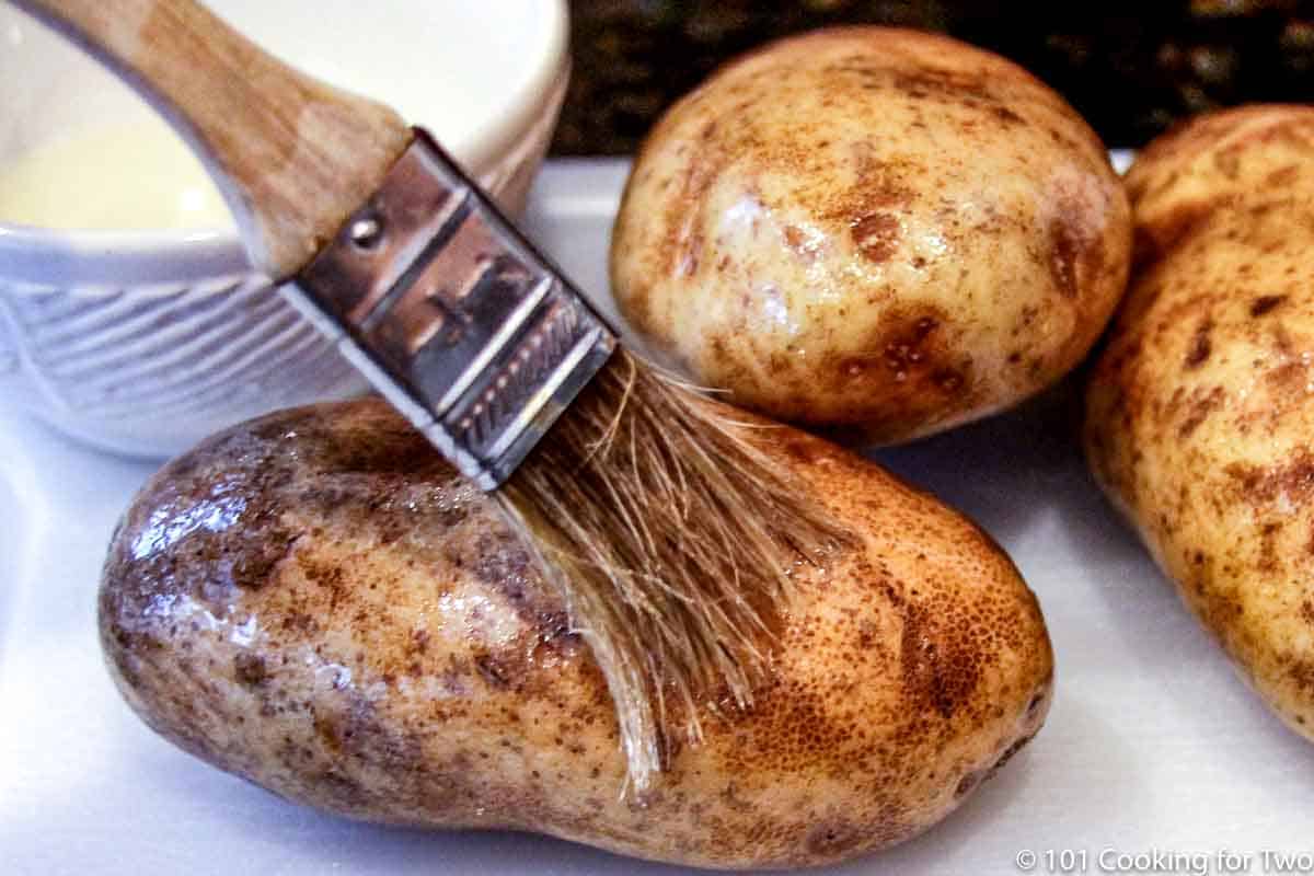 brushing cleaned potatoes with oil.