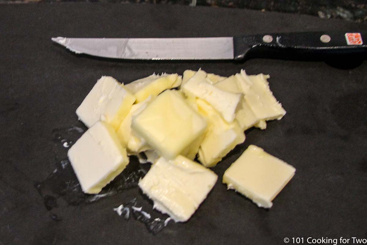 butter chopped up on black board.