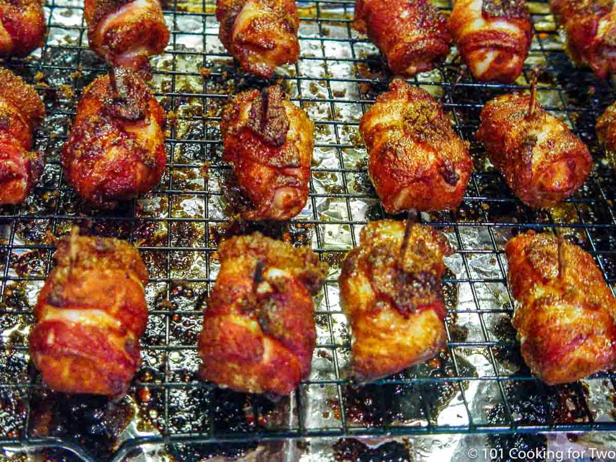 cooked bacon wrapped chicken still on baking rack.