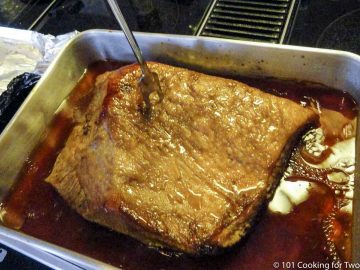 cooked brisket with a large for checking for tender