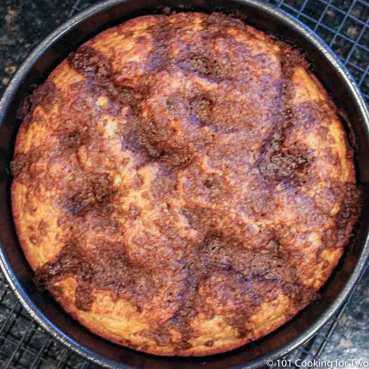 cooked coffee cake in black pan.